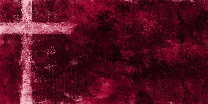 light cross on dark red textured painting background